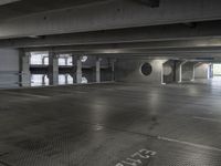 a empty parking garage with light coming through the windows and a floor grid pattern in place to protect from people