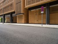 two buildings on the side of an empty street with no entry sign on it in front of them