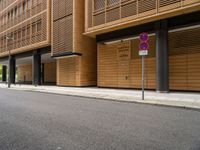 two buildings on the side of an empty street with no entry sign on it in front of them