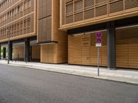 two buildings on the side of an empty street with no entry sign on it in front of them