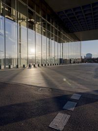 the sun rises over a closed airport lobby with a small fire hydrant on the pavement