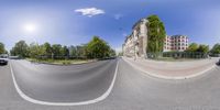 a 360 - view image of an intersection in the city with cars parked on a side of it