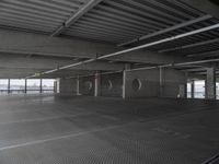 a parking garage with a ramp and several round spaces for bikes to move through it