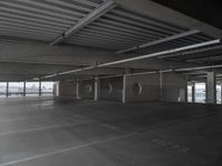 a parking garage with a ramp and several round spaces for bikes to move through it