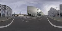 an image of an empty city road with buildings in the background looking like a fish eye