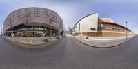 a circular photo of an empty city street with cars driving on the street behind it