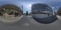 two 360 - panes of a large industrial city street with an overpass and a tunnel