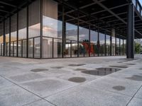 a person standing outside a building in a large area of cement and concrete tiles, with multiple circles