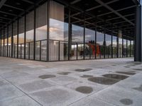 a person standing outside a building in a large area of cement and concrete tiles, with multiple circles