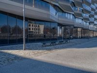 the large office building is located in the center of a cobblestone plaza of the city