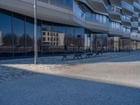 the large office building is located in the center of a cobblestone plaza of the city