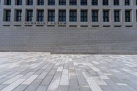 an empty courtyard with a stone block wall and a blue sky in the background that reads humboldt forum