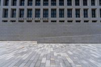 an empty courtyard with a stone block wall and a blue sky in the background that reads humboldt forum