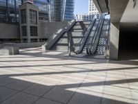 a building with escalators in the background of skyscrapers and windows in it