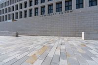 the large stone sidewalk is next to the building where it is housed as the hummellot forum