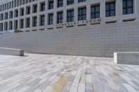 the large stone sidewalk is next to the building where it is housed as the hummellot forum