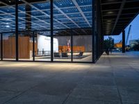 the view of an outdoor meeting room at night with large windows that can be open for people