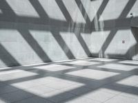 a room with some windows and shadows on the floor or floor to ceiling tiles in it