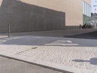 a man riding a skateboard down the side of a road holding onto an open hand