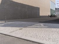 a man riding a skateboard down the side of a road holding onto an open hand