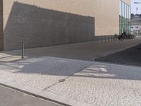 a man riding a skateboard down the side of a road holding onto an open hand