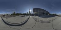 a big open view of a skateboard park with poles, skate boards and other things