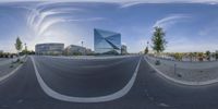 there is a street and building reflected in the glass on the building across the road