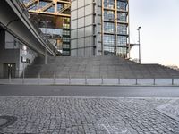 a skateboarder is jumping in front of a tall building that is also in business