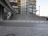 a skateboarder is jumping in front of a tall building that is also in business