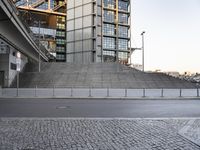 a skateboarder is jumping in front of a tall building that is also in business