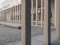 a woman in a blue suit is walking past a building that looks out into a distance