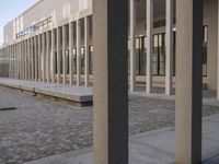 a woman in a blue suit is walking past a building that looks out into a distance