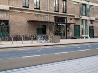 the bike is parked at the entrance of a building with bikes parked outside of it