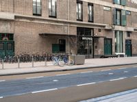 the bike is parked at the entrance of a building with bikes parked outside of it