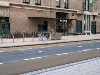 the bike is parked at the entrance of a building with bikes parked outside of it