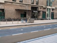 the bike is parked at the entrance of a building with bikes parked outside of it