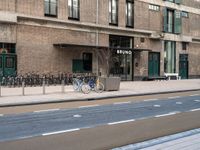 the bike is parked at the entrance of a building with bikes parked outside of it