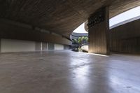 concrete floor with lots of windows in it near a building and trees under a roof