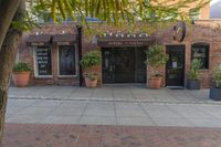 the exterior of an office building where it appears to be open with potted plants