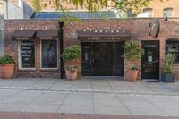 the exterior of an office building where it appears to be open with potted plants