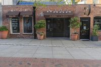 the exterior of an office building where it appears to be open with potted plants