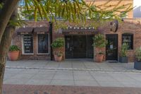 the exterior of an office building where it appears to be open with potted plants