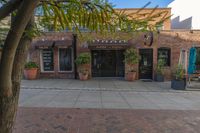 the exterior of an office building where it appears to be open with potted plants