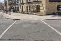 this is an image of city street intersection, with red stop sign and buildings in background