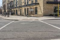 this is an image of city street intersection, with red stop sign and buildings in background