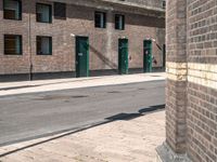 there is a building in the background with a green door and fire hydrant on the sidewalk