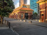 this photo shows a bus stop near an empty street and buildings on the side of the road