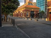 this photo shows a bus stop near an empty street and buildings on the side of the road