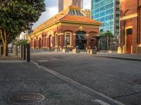 this photo shows a bus stop near an empty street and buildings on the side of the road