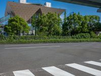 the city of richmond has long white arrows running down it's side and a pedestrian crossing over an expressway